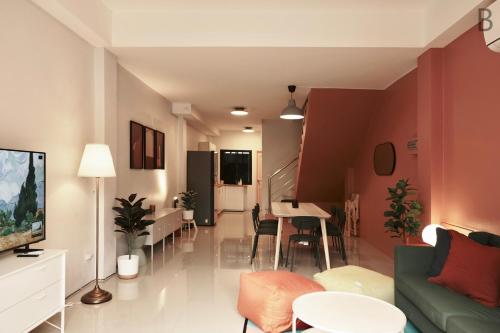 a living room with a couch and a table at 4 bedrooms, Private & Cozy house @ Walking Street in Chiang Rai