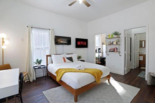 a bedroom with a large bed with a yellow blanket at Cozy Upstairs Studio Near Downtown and the River in Sacramento