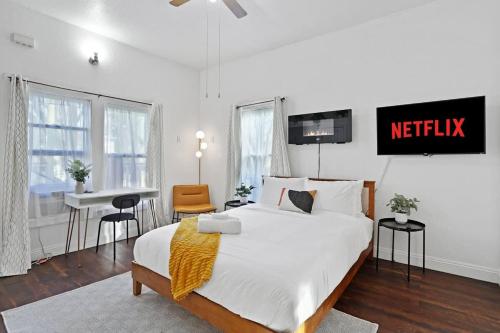 a bedroom with a bed with a netflix sign on the wall at Cozy Upstairs Studio Near Downtown and the River in Sacramento