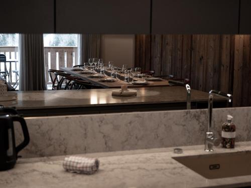 un miroir de salle de bain avec une table avec des verres à vin dans l'établissement Appartement de luxe avec conciergerie 5*, vue montagne, 3 chambres, ski room - FR-1-613-125, à Les Allues