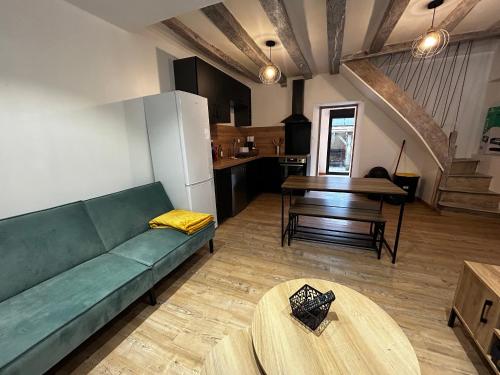 un salon avec un canapé vert et une table dans l'établissement Maison de charme T3 rénovée avec jardin à Vicq-sur-Gartempe, proche La Roche-Posay - FR-1-541-165, à Vicq-sur-Gartempe