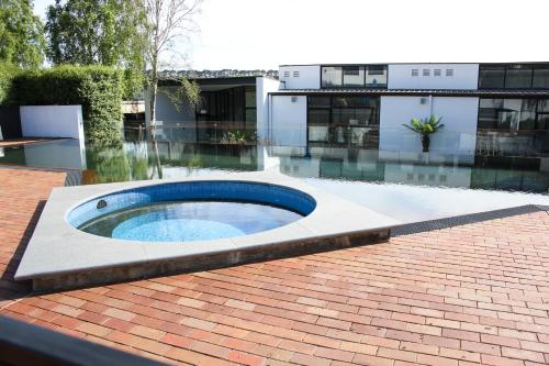 a swimming pool in the middle of a yard with a building at Waurn Ponds Estate in Waurn Ponds