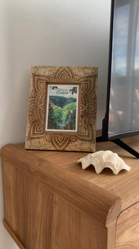 a picture frame sitting on top of a wooden table at Vue mer sur la Marina, Le Juliana in Pointe-à-Pitre