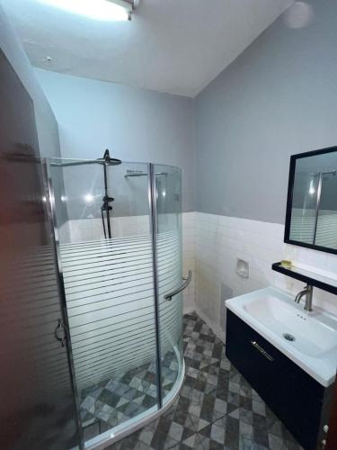 a bathroom with a glass shower and a sink at Seri Selasih Klebang! in Malacca