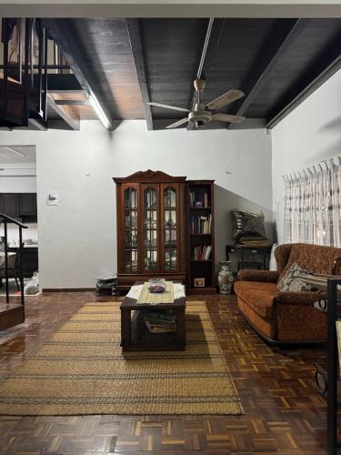 a living room with a couch and a coffee table at Seri Selasih Klebang! in Malacca