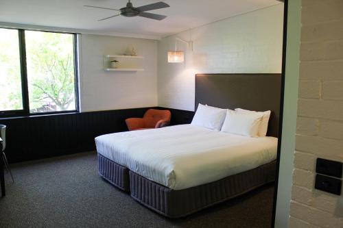 a hotel room with a bed and a chair at Waurn Ponds Estate in Waurn Ponds