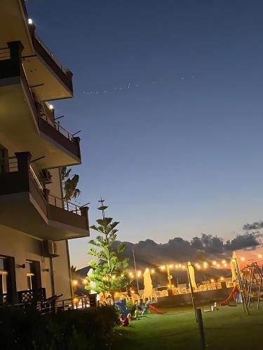 a christmas tree in a yard next to a building at Sunrise Hotel Orikum in Orikum