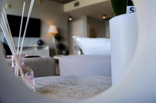 a vase with sticks in it sitting on a table at Luxury Midtown Miami Apartment in Miami