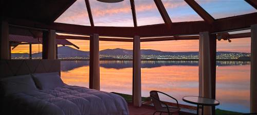 a bedroom with a bed and a view of the water at Titicaca Vista Atardecer in Puno