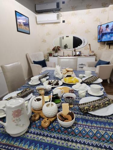 a table with a blue and white table cloth with food on it at Hotel bereka in Mtskheta