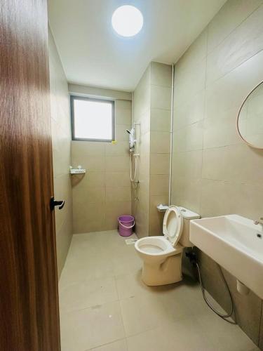a bathroom with a toilet and a sink at Sleek Cottage GLEN 1 HomeStay Kuching in Kuching
