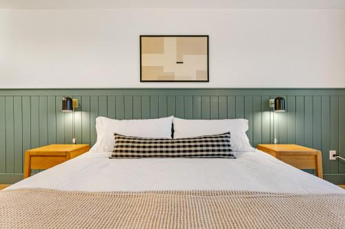 a bedroom with a large bed with two night stands at Harbor Views 3 - Walkable in the Heart of Auke Bay in Mendenhaven
