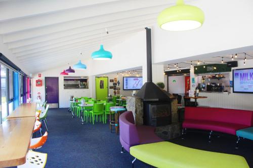 a restaurant with colorful furniture and tables and chairs at Stillwell Hotel in Charlotte Pass