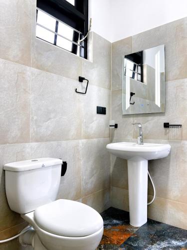 a bathroom with a toilet and a sink at Polelanka guest house in Mirissa