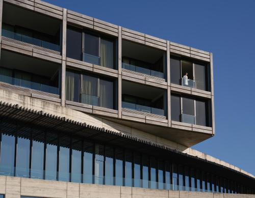 a man stands on a balcony of a building at RACV Torquay Resort in Torquay