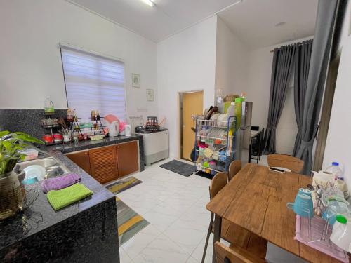 a kitchen with a sink and a counter top at Teratak Zaa D’Homestay in Kota Bharu