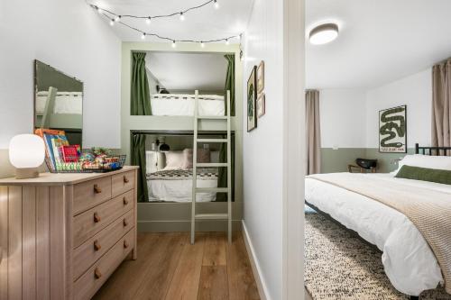 a bedroom with a bed and a dresser with a mirror at Harbor Views 1 - Walkable in the Heart of Auke Bay in Mendenhaven