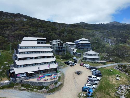 an aerial view of a resort with cars parked in a parking lot at Stillwell Hotel in Charlotte Pass
