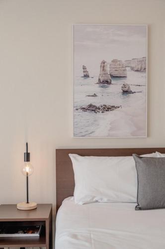 a bedroom with a bed and a picture on the wall at Mitchell On Main in Bairnsdale