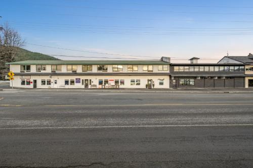 a large white building on the side of a street at Harbor Views 1 - Walkable in the Heart of Auke Bay in Mendenhaven