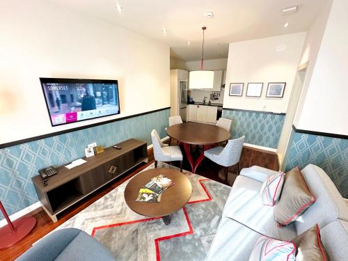 a living room with a couch and a table at Somerset City Centre Atyrau in Atyraū
