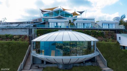 a house with a dome on top of it at La Canopée vue sur mer in Nosy Be