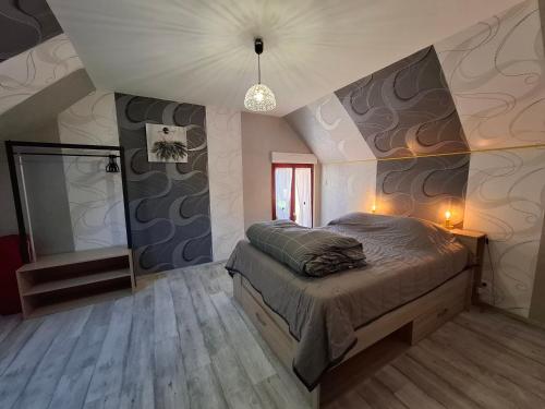 a bedroom with a large bed in a room at Le paradis des caves in Châteauvieux