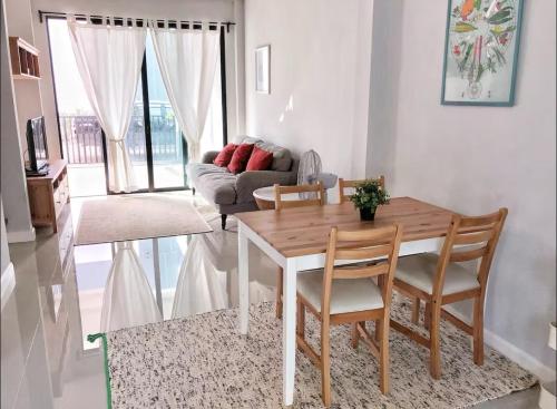 a living room with a table and chairs and a couch at 3 Bedrooms townhome, gated community KKC in Ban Si Than