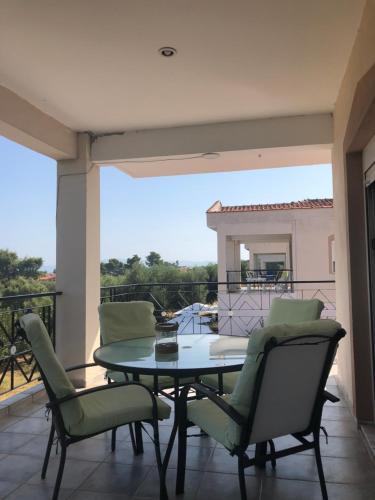 a patio with a table and chairs on a balcony at DERES Apartments in Hanioti