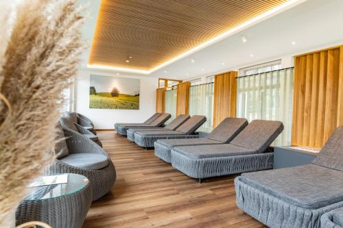 a waiting room with four couches and chairs at Göbel´s Vital Hotel Bad Sachsa in Bad Sachsa