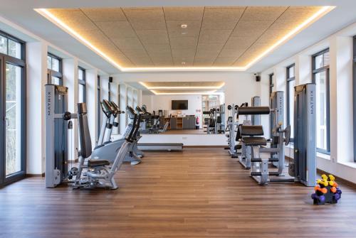 a gym with treadmills and machines in a room at Göbel´s Vital Hotel Bad Sachsa in Bad Sachsa