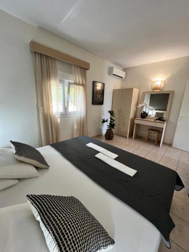 a bedroom with a large black and white bed at DERES Apartments in Hanioti