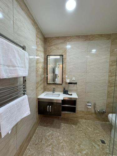 a bathroom with a sink and a mirror at Paradise- 2 rooms in Sumqayyt