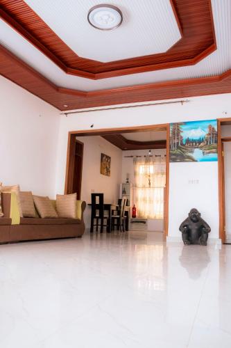 a living room with a couch and a table at Kivu Greenstars Apartment in Gisenyi