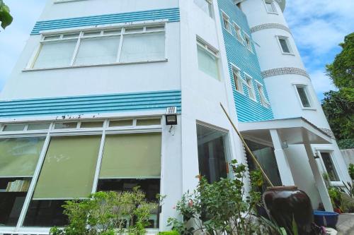 a blue and white building with a tower at Here Innstead Boracay in Boracay