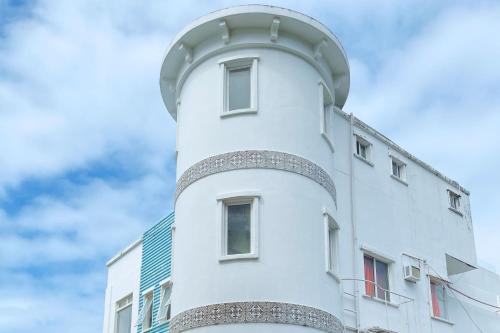 a white building with a observatory on top of it at Here Innstead Boracay in Boracay