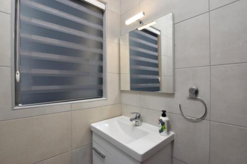 a white bathroom with a sink and a mirror at 2 bedroom Flat close to Valletta & Sliema - Orion3 in Msida