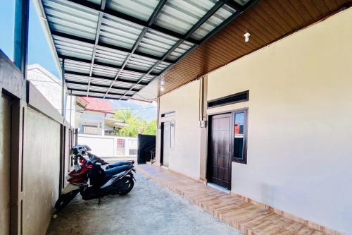 a motor scooter parked in a hallway of a building at RedDoorz Syariah at Florensa Banda Aceh in Lamglumpang