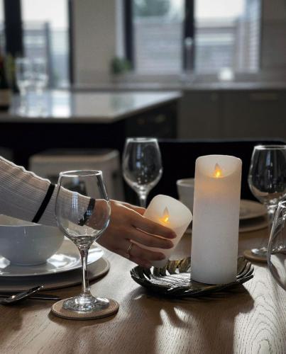 a person sitting at a table with candles and wine glasses at The Penthouse - Allocated Parking with City Views in Ripon