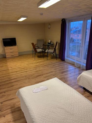 a bedroom with a bed and a table and chairs at Narva Kangelaste 2 Apartments in Narva