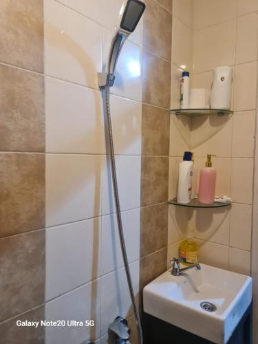 a shower head over a sink in a bathroom at Mountain View at The Edge in Cimindi-hilir