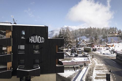 a building with the word hollywood on it in the snow at Haunold Homes in San Candido