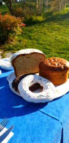 a table with a cake and a piece of cake at Le Calvie, country house in Camerino