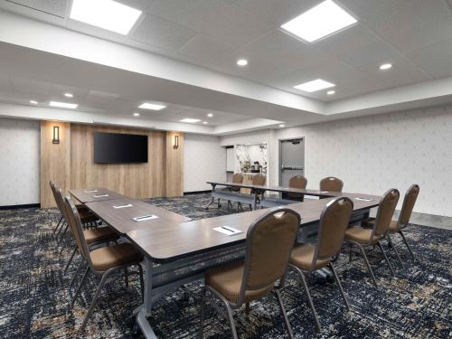 a conference room with a large table and chairs at Hyatt Place Kansas City/Overland Park/Metcalf in Overland Park