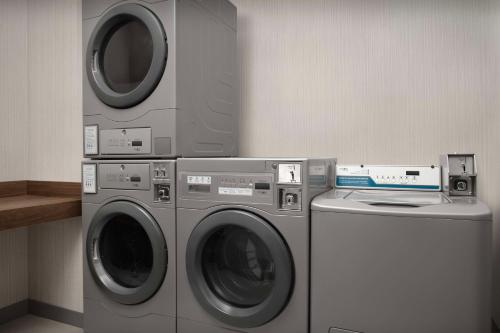 two washing machines and a washer and dryer in a room at Hilton Garden Inn Atlanta North/Johns Creek in Johns Creek