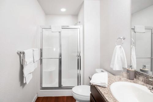 a bathroom with a shower and a toilet and a sink at Central Urban Stay with Gym in Greeley