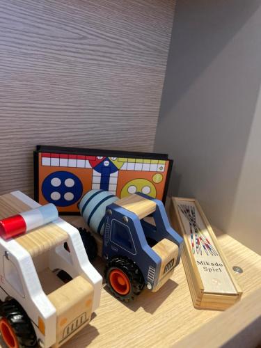a toy truck and a toy dump truck on a table at HOFERHOF Schladming -Dachstein in Schladming