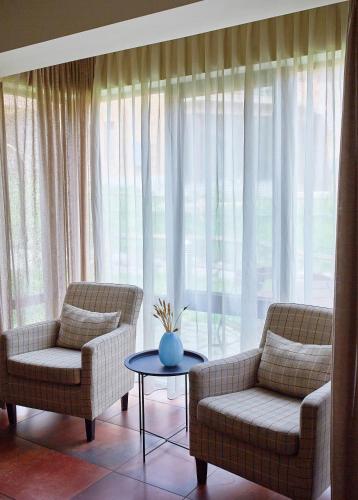 a living room with two chairs and a table at Teghenis Resort in Tsaghkadzor