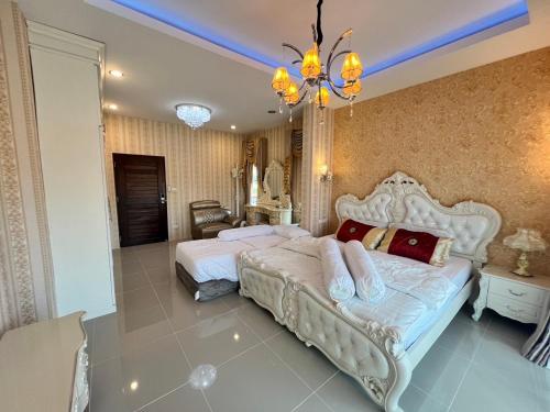 a bedroom with two beds and a chandelier at Ban MeeDee in Chiang Mai