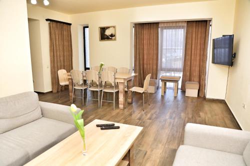 a living room with a couch and a table at Teghenis Resort in Tsaghkadzor